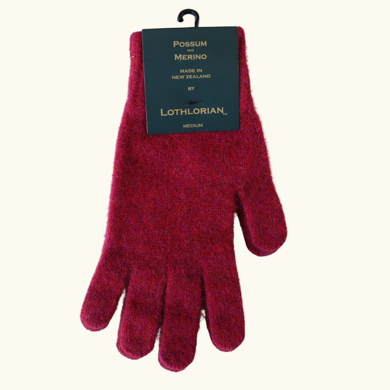 Raspberry possum and merino wool gloves flat lay on white background