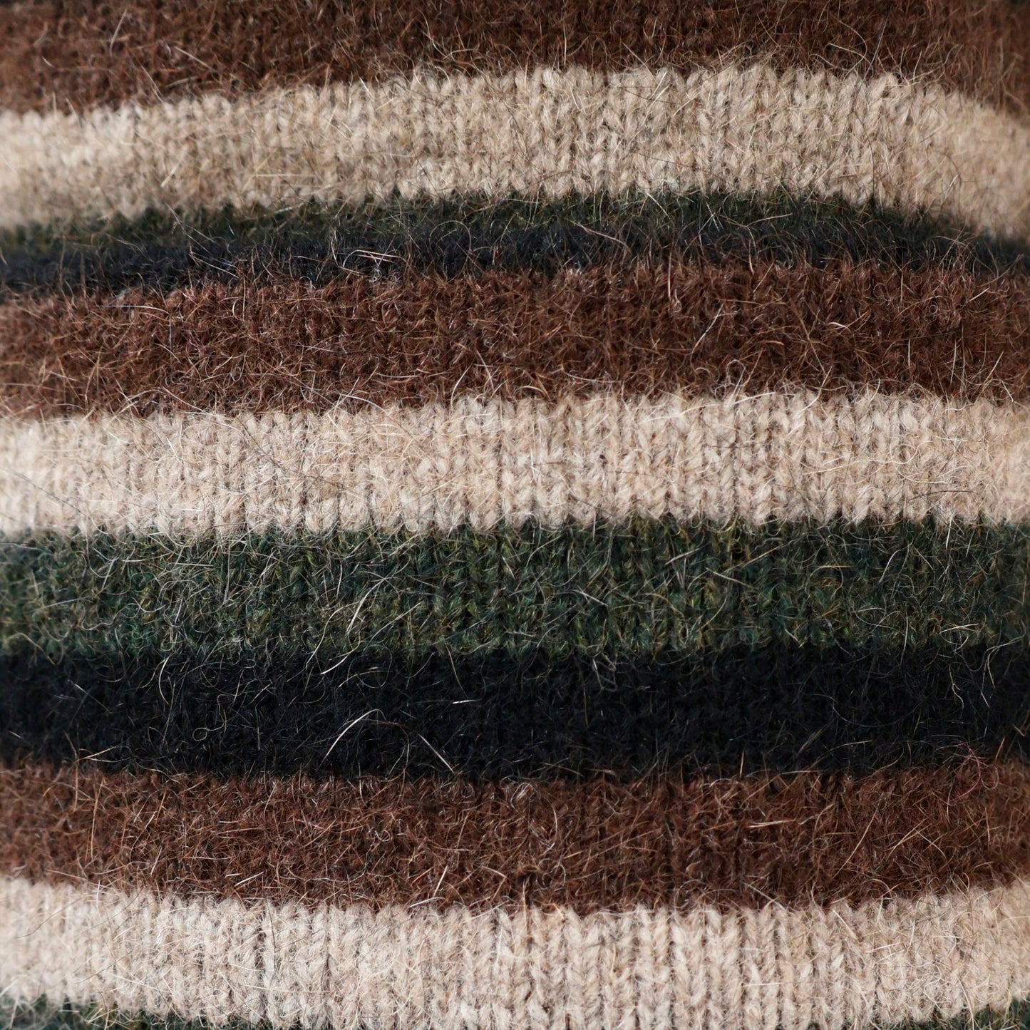 Black, green and brown possum and merino wool striped beanie close up of fabric. Warm, soft and comfortable unisex winter wool beanie.