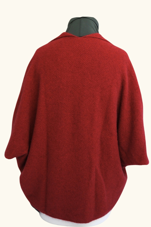 Red possum and merino wool cape with button on mannequin. Warm, soft and lightweight Lothlorian women's wool cape