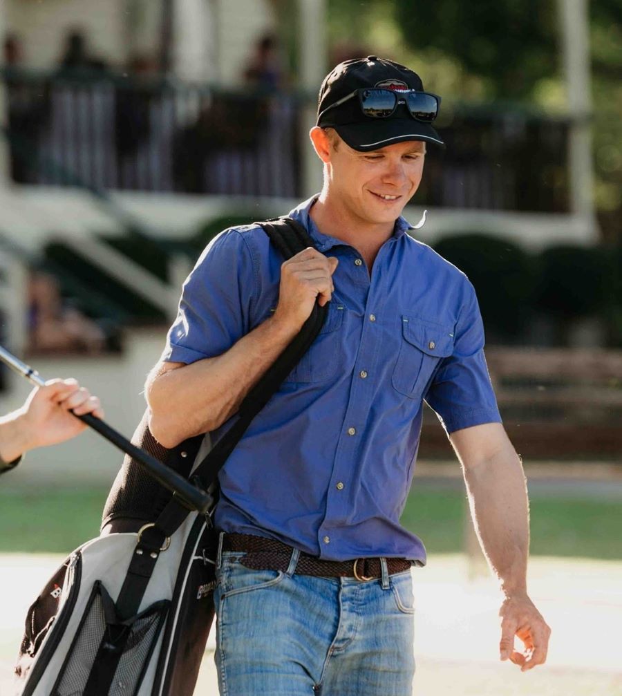 Navy mens bamboo button up short sleeve shirt front view on male model on golf course