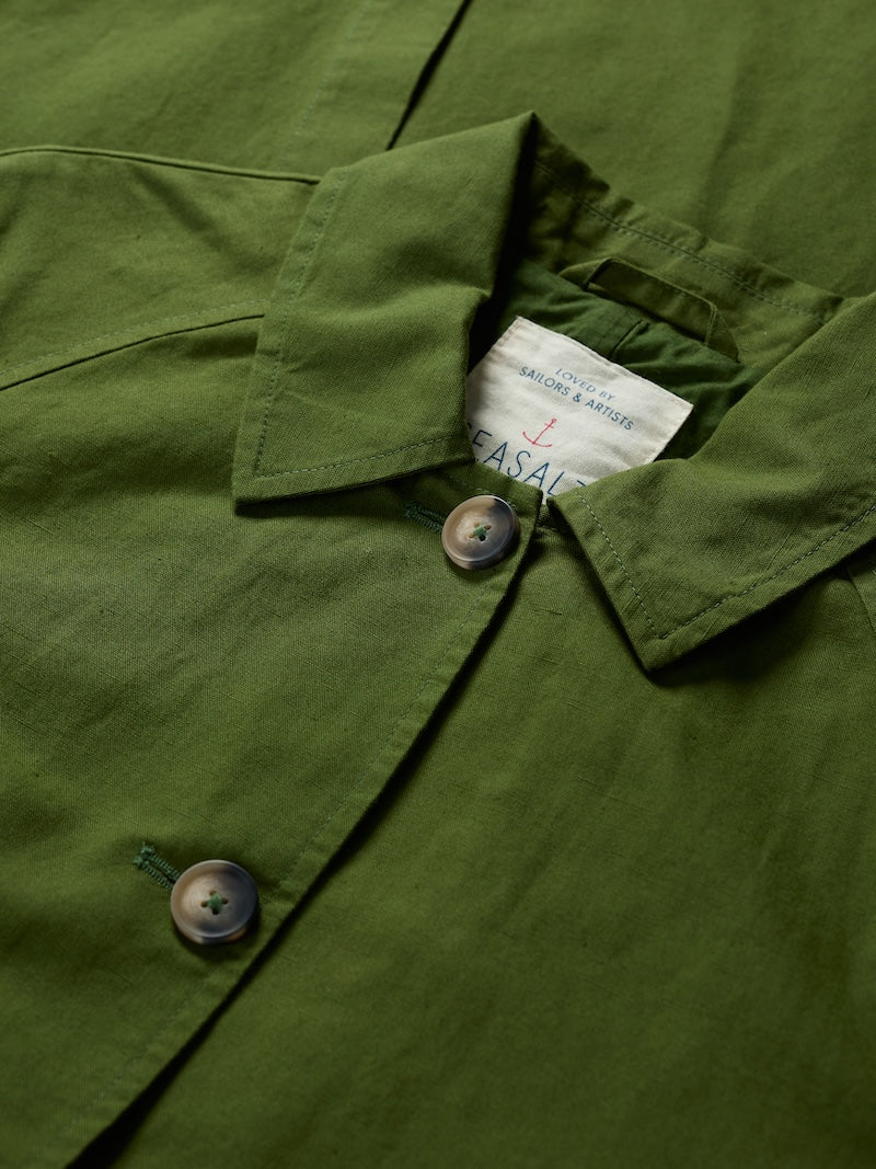 Close-up of a green shirt with a brand label inside the collar.