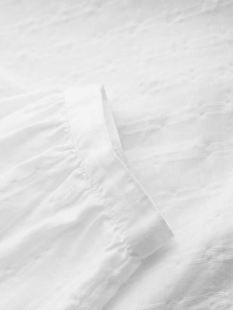 Close-up of white fabric with subtle texture