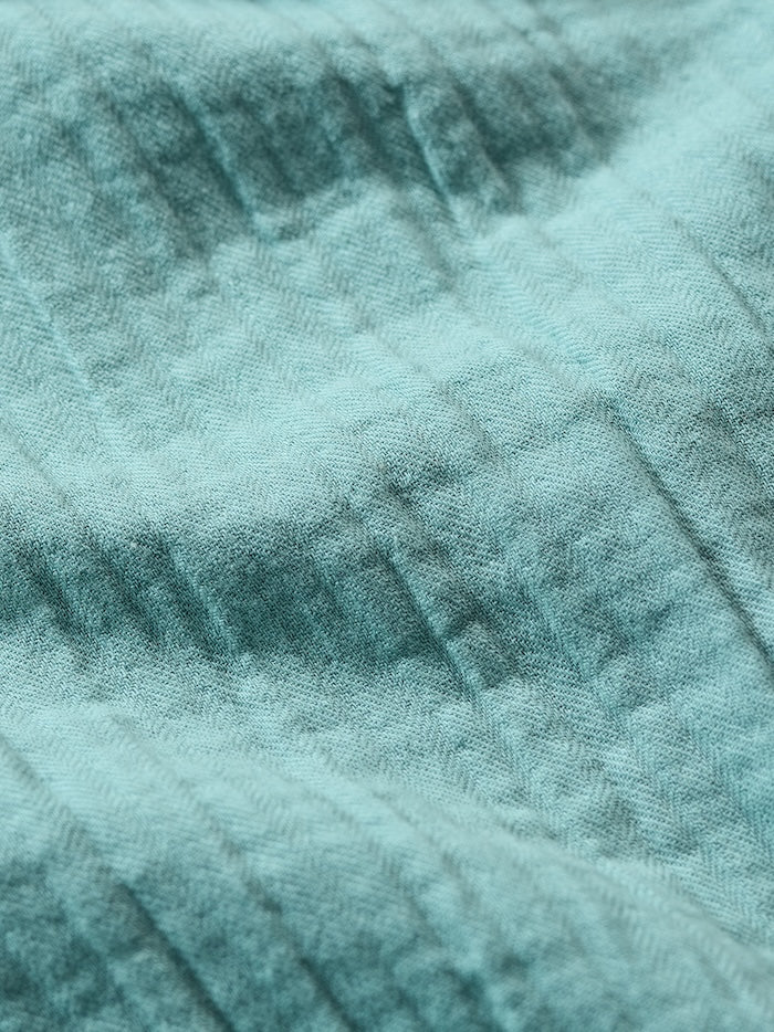 Close-up of a textured teal fabric surface