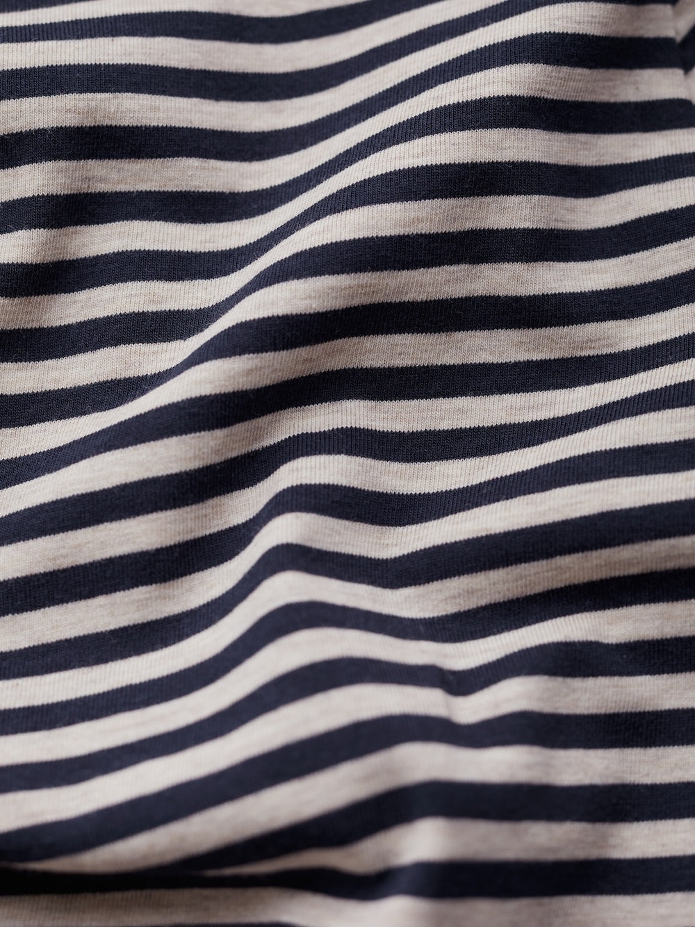 Close-up of a striped fabric with navy and beige horizontal lines.