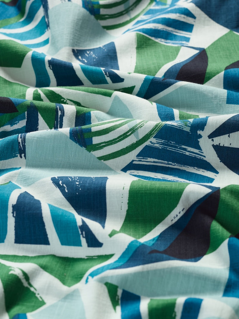 Close-up of fabric with blue, green, and white abstract pattern