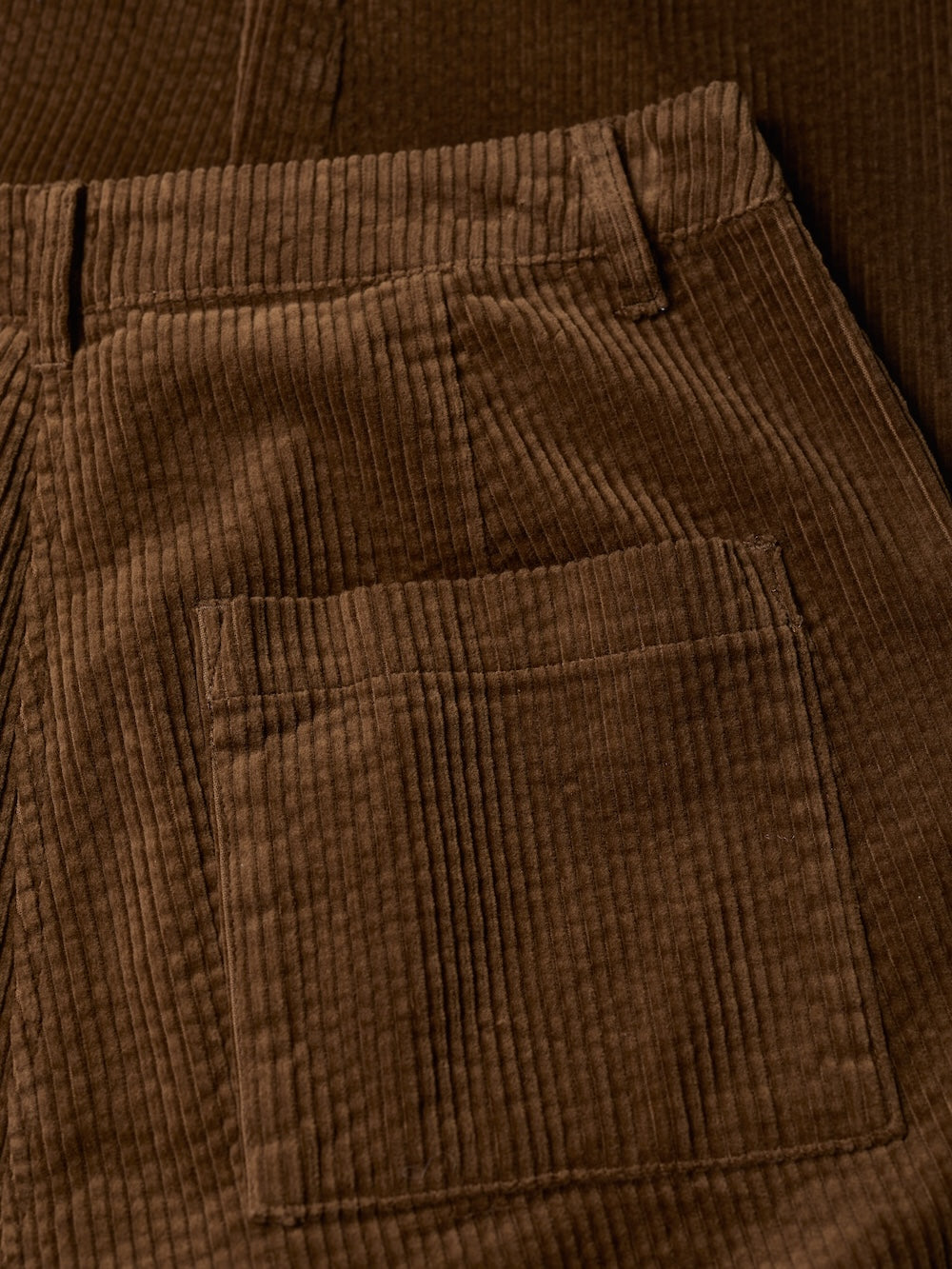 Close-up of brown corduroy pants with a pocket