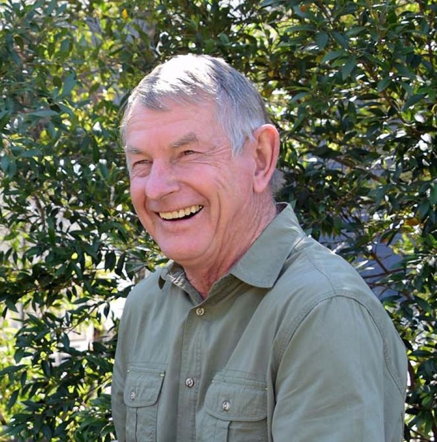 Mens khaki coloured bamboo button up shirt on male model sitting down