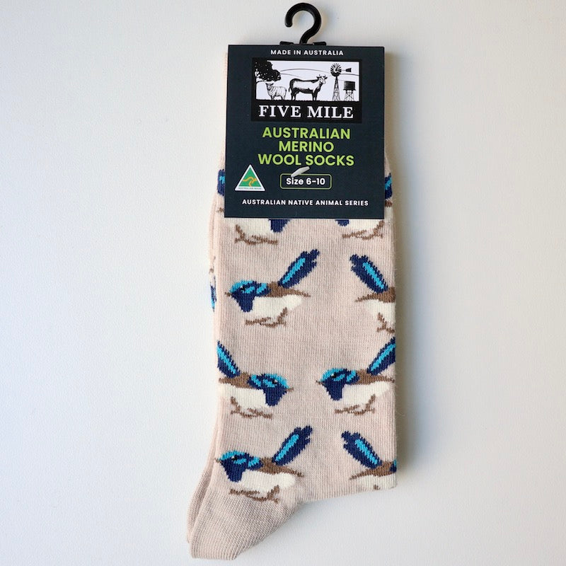 Cream coloured merino wool sock with blue wren design, on a white background