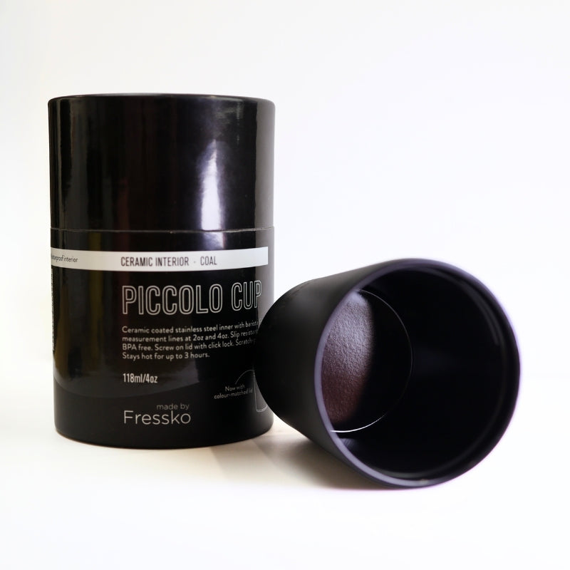 Black Fressko ceramic piccolo reusable cup on white background. Chemical free, slip resistant, spill proof coffee cup.