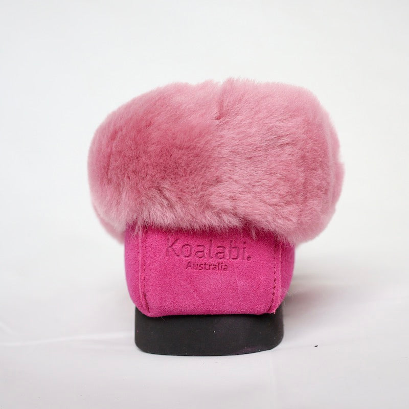 Dark pink sheepskin moccasins back angle showing branding and sheepskin