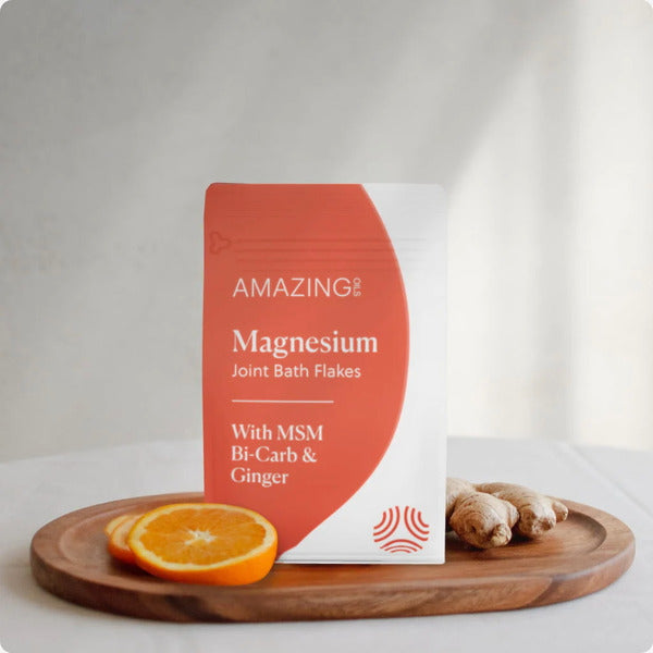Magnesium Joint Bath Flakes in orange and white packet. Supports joints, soothes muscle tension & promotes restful sleep. Enhances circulation & improves skin health.