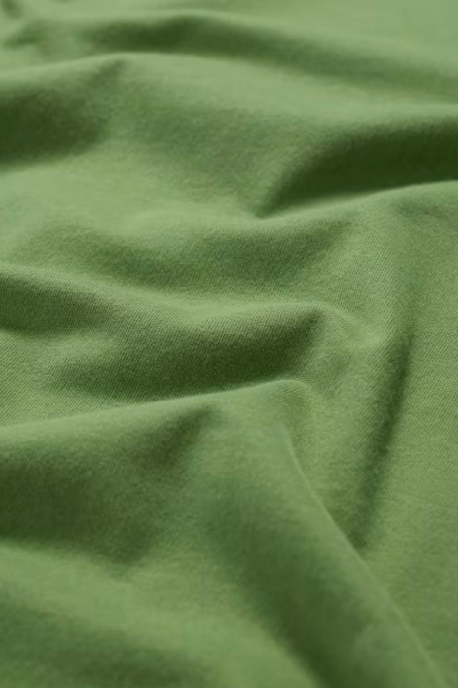 Close-up of green fabric with folds