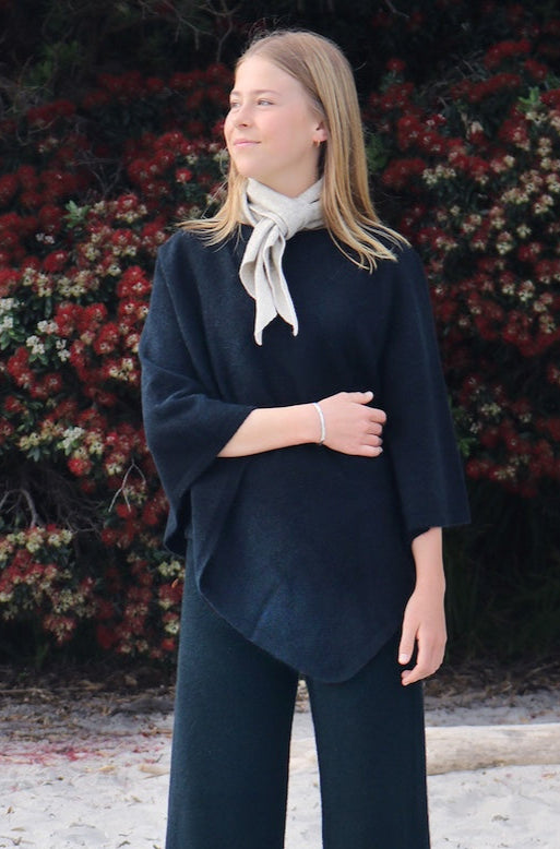 Woman wearing blue possum, merino wool & silk poncho. Warm, lightweight & cosy women's poncho