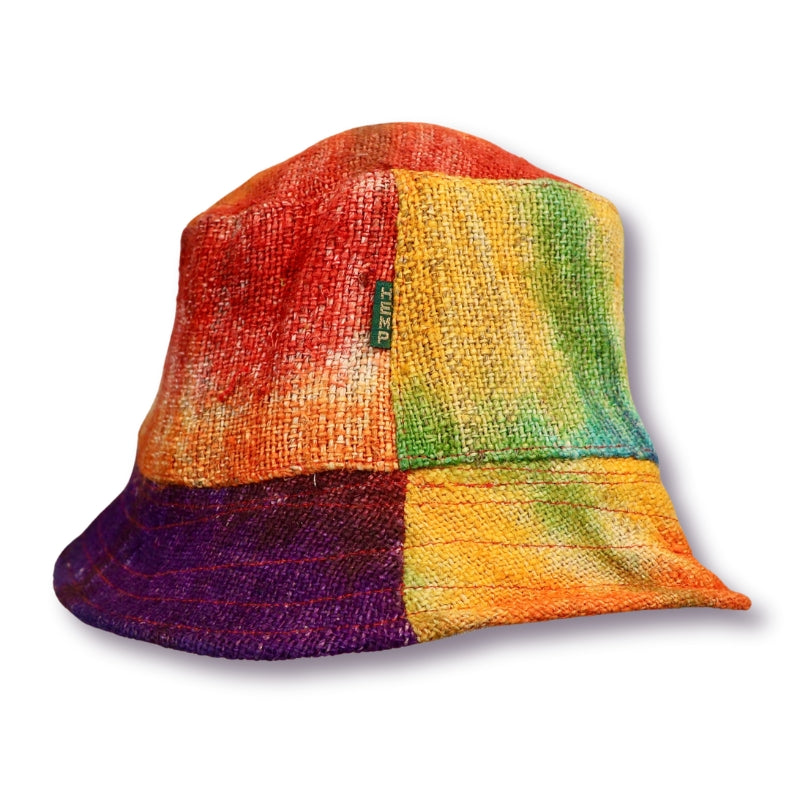 Multi coloured tie dye hat made from hemp on white background. Red, purple, green and yellow tie dye bucket hat