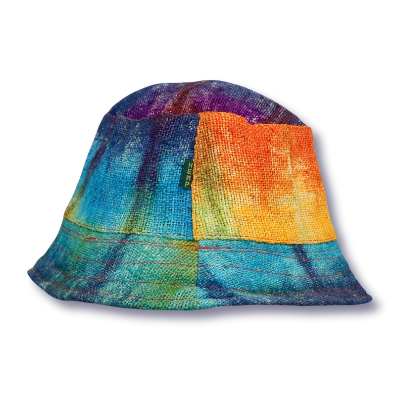 Multi coloured tie dye hat made from hemp on white background. Blue, orange, green and yellow tie dye bucket hat