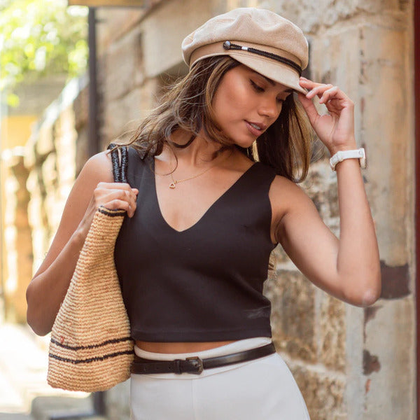 Brown women's fisherman cap on female model. Retro-style corduroy cap.