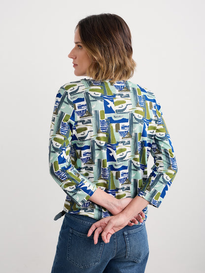 Woman wearing a patterned shirt with a plain background