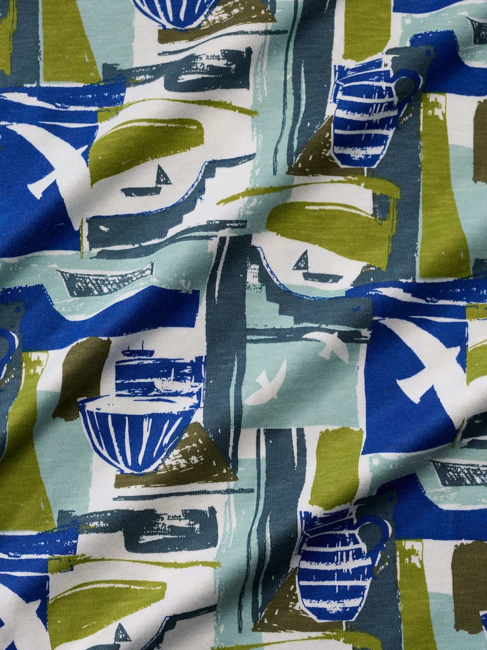 Close-up of fabric with abstract pattern in blue, green, and white.