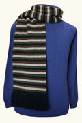 Black, green, brown coloured striped possum and merino wool scarf wrapped around neck of mannequin wearing blue wool jumper on white background. Lothlorian warm, soft unisex winter scarf