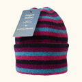 Purple, black and blue striped possum and merino wool beanie on a white background. Warm, comfortable and soft merino wool unisex beanie 