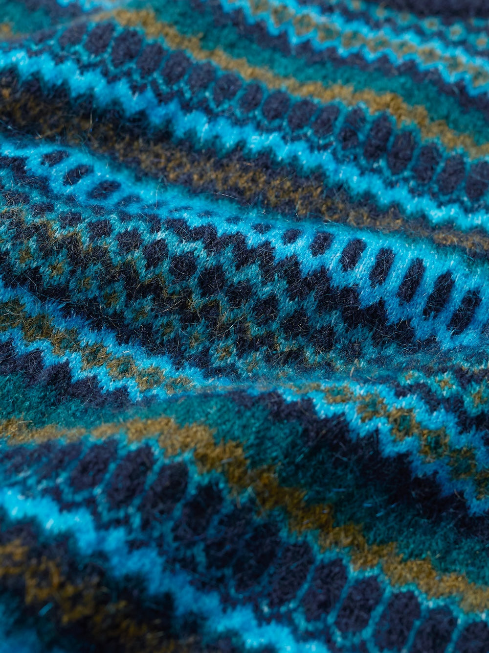 Close-up of a textured fabric with blue and brown pattern