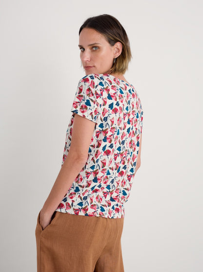 Woman wearing a floral patterned shirt with a plain background