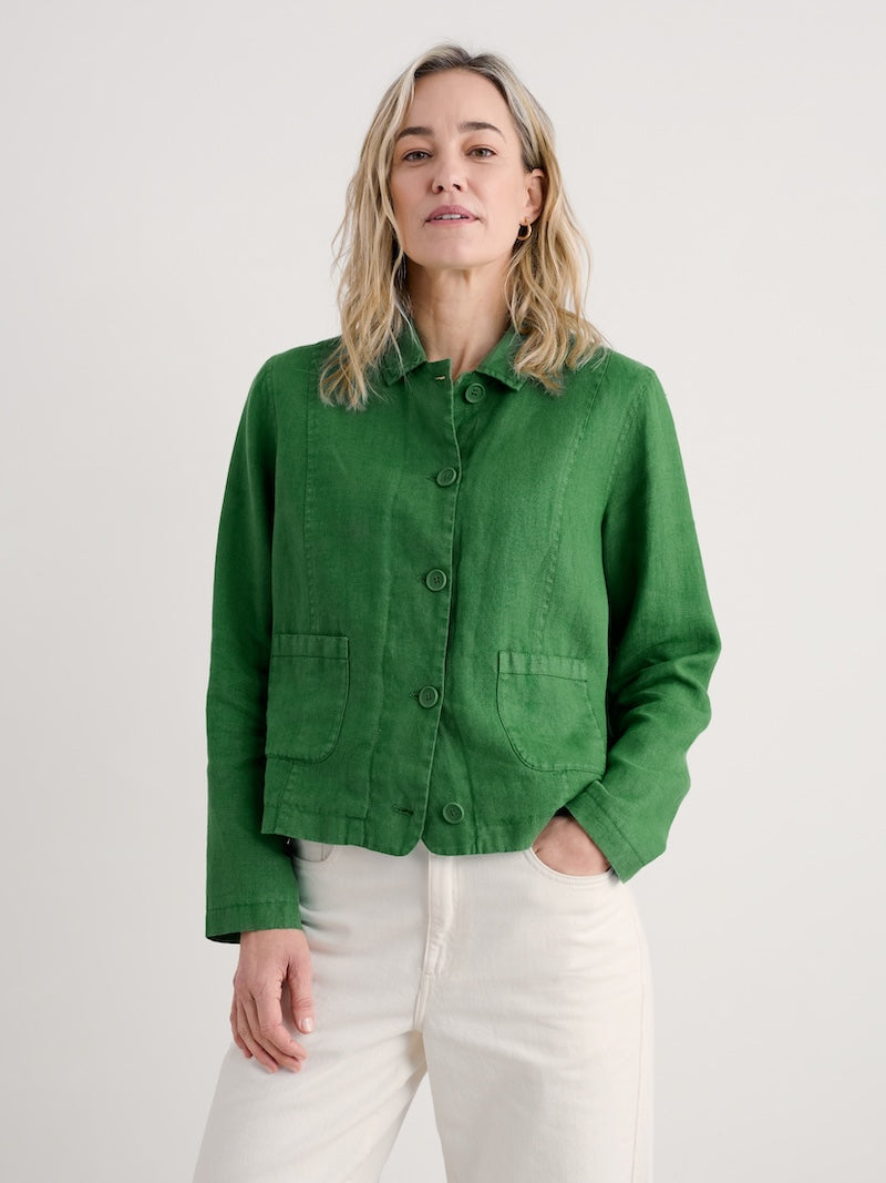 Woman wearing a green jacket on a white background