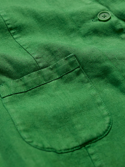 Close-up of a green jacket with a pocket and button