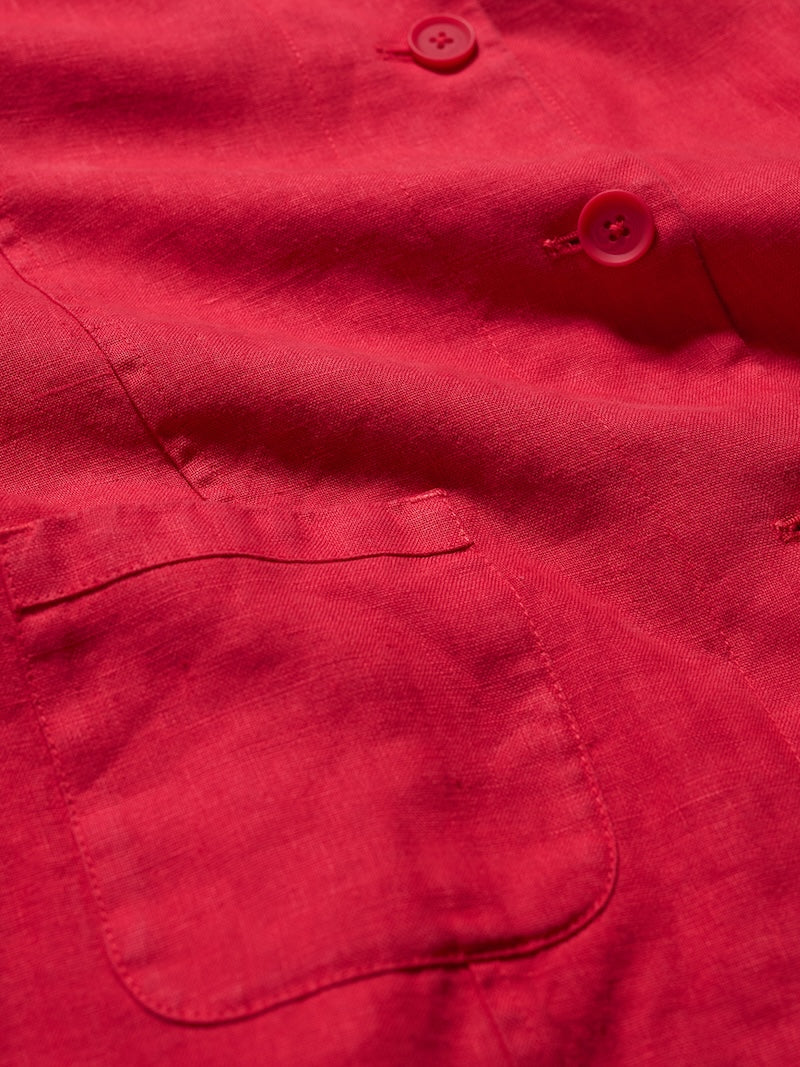 Close-up of a pink jacket with a pocket and buttons.
