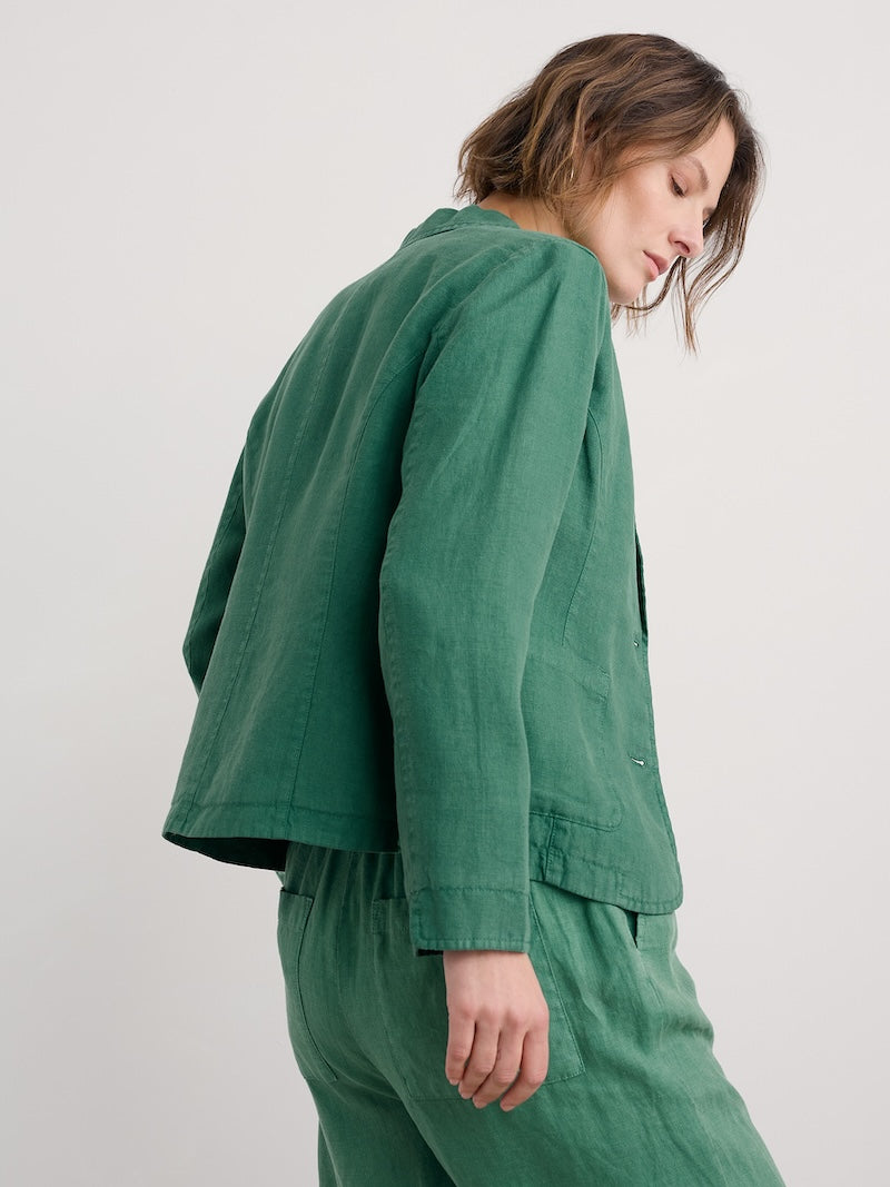 Woman wearing a green outfit against a white background