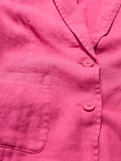 Close-up of a pink jacket with buttons and a pocket