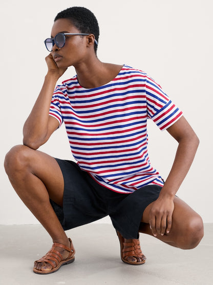 Woman wearing a red, white, and blue striped shirt on a plain background