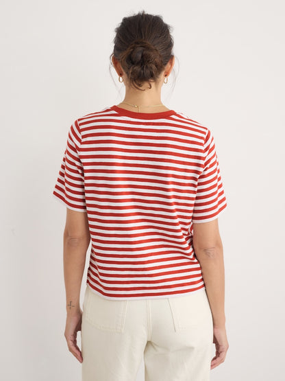 Person wearing a red and white striped shirt against a plain background