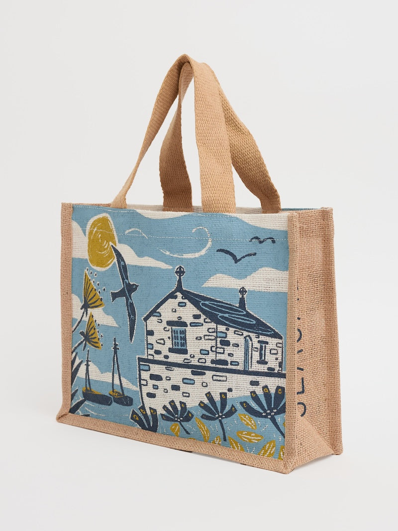 Tote bag with a house design on a blue background