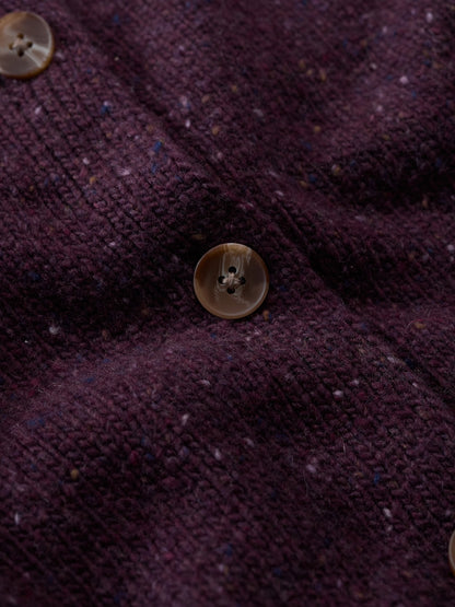 Close-up of a textured purple fabric with buttons