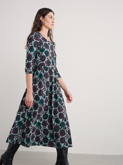 Woman wearing a floral dress on a plain background