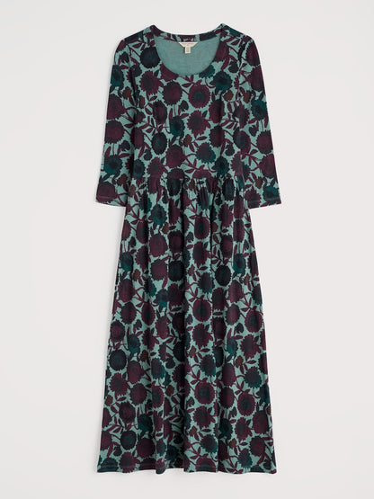 Long floral dress with a pattern of purple and green on a white background