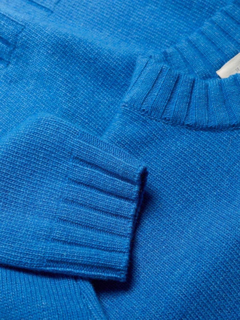 Close-up of a blue sweater with ribbed texture