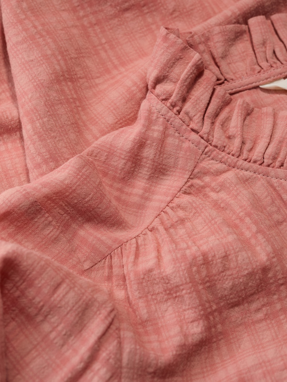 Close-up of pink fabric with texture and folds
