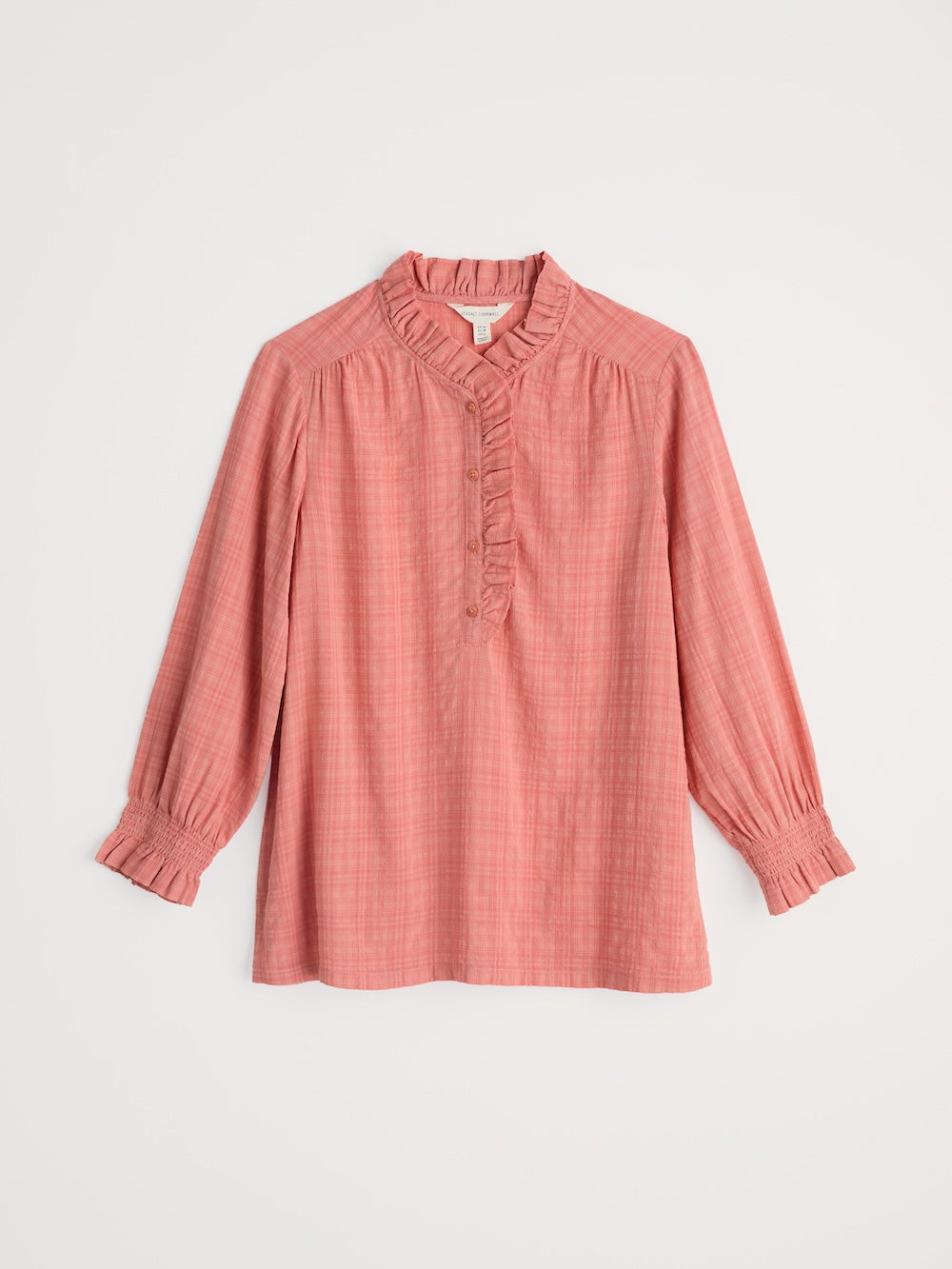 Pink blouse with long sleeves on a light gray background