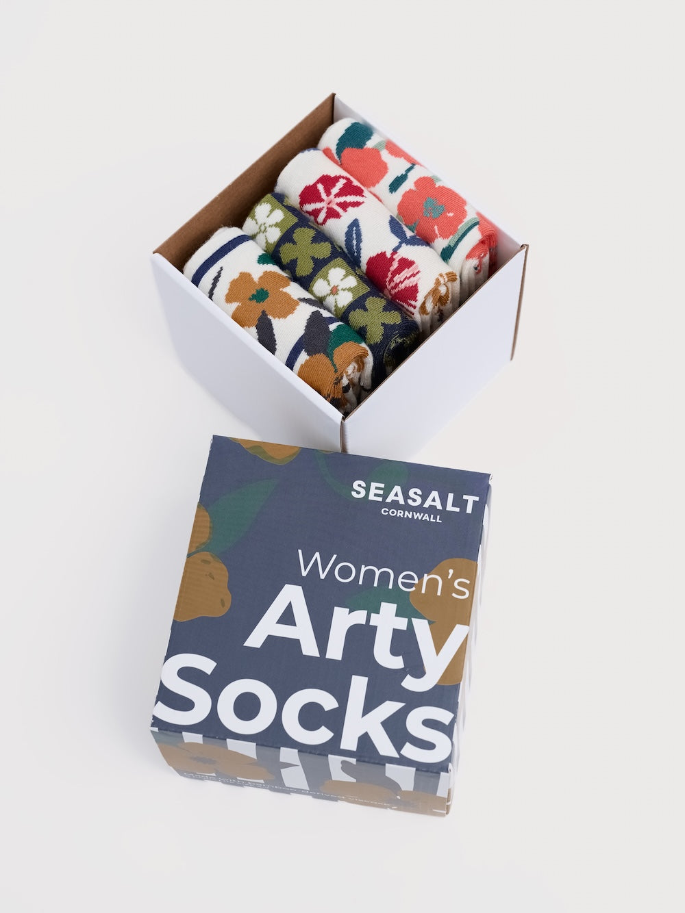 Box of floral-patterned socks with Seasalt Cornwall packaging on a white background
