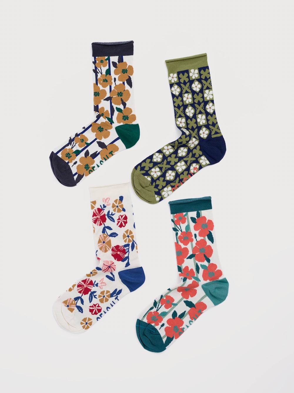 Four pairs of floral-patterned socks on a white background