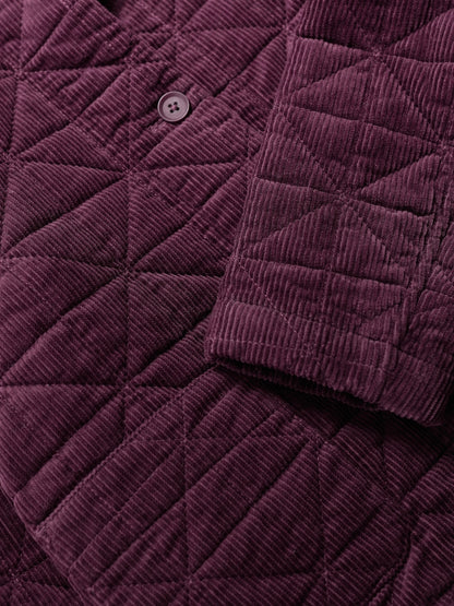 Close-up of a purple quilted jacket with button detail
