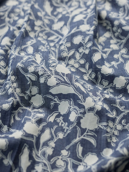 Close-up of blue fabric with white floral pattern