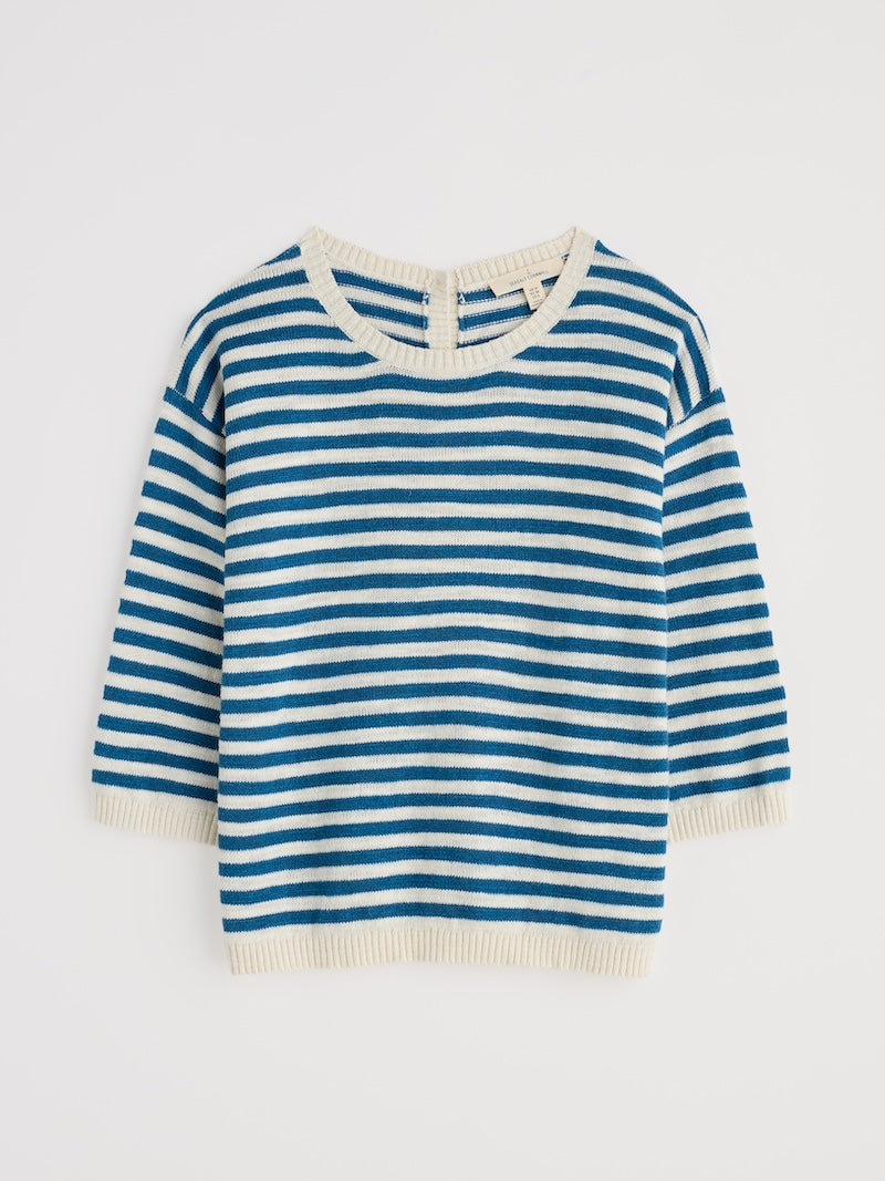 Blue and white striped sweater on a light gray background