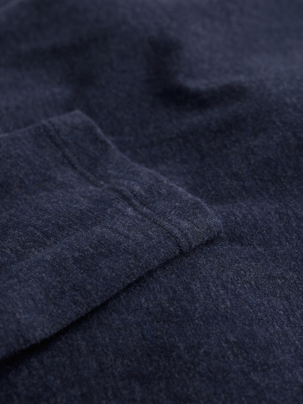 Close-up of dark blue fabric with a subtle pattern