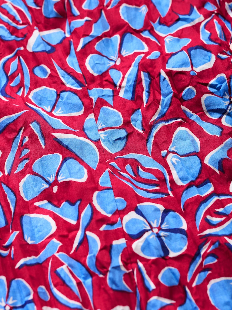 Red fabric with blue floral pattern