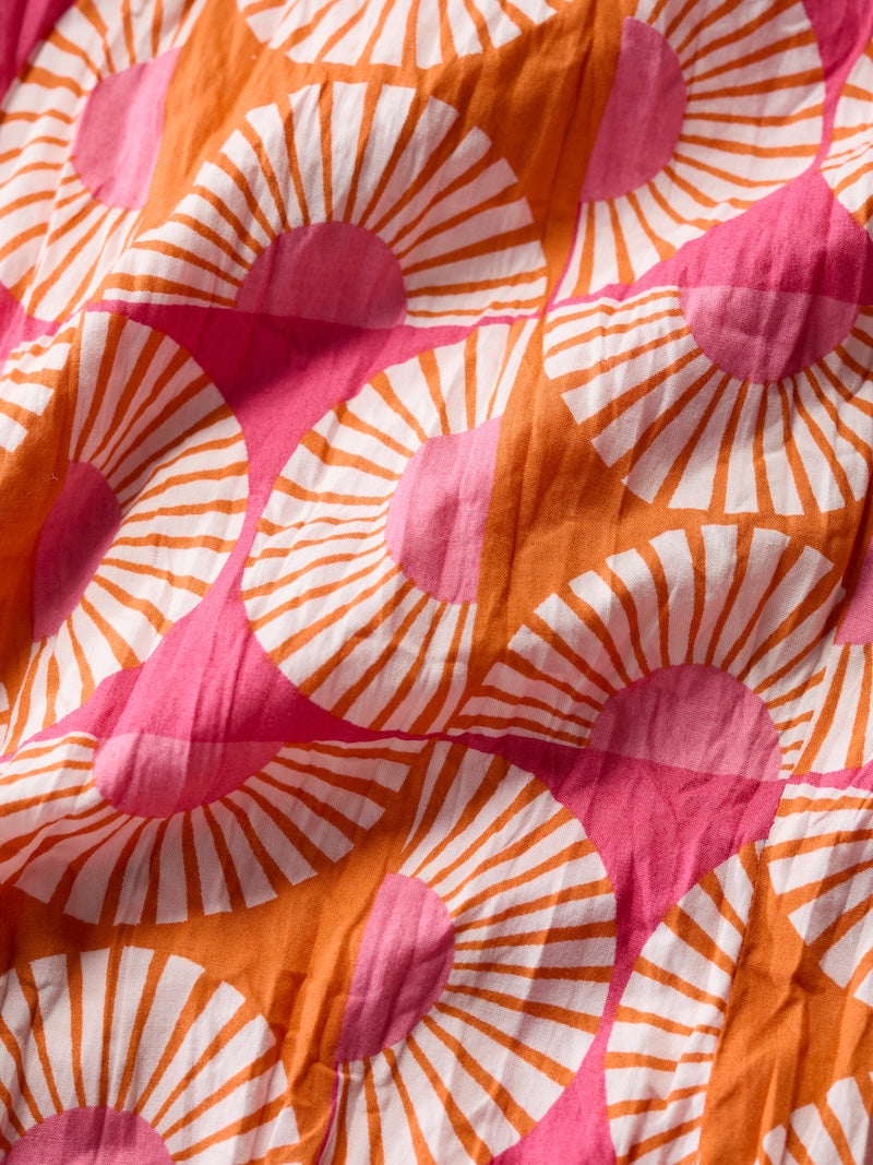 Close-up of fabric with pink and orange floral pattern