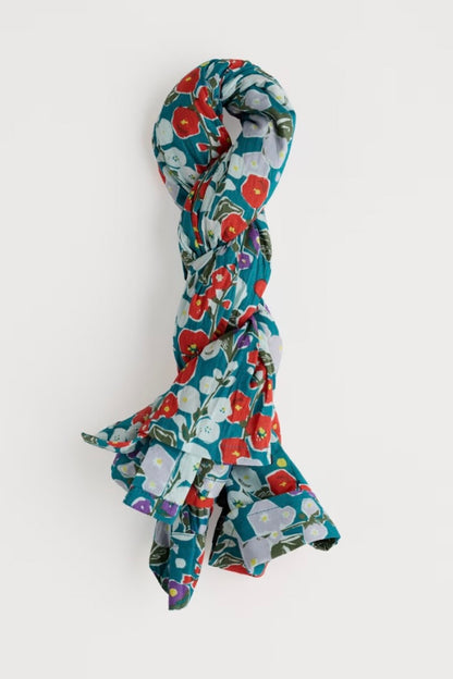 Floral patterned rolled up shirt on a white background