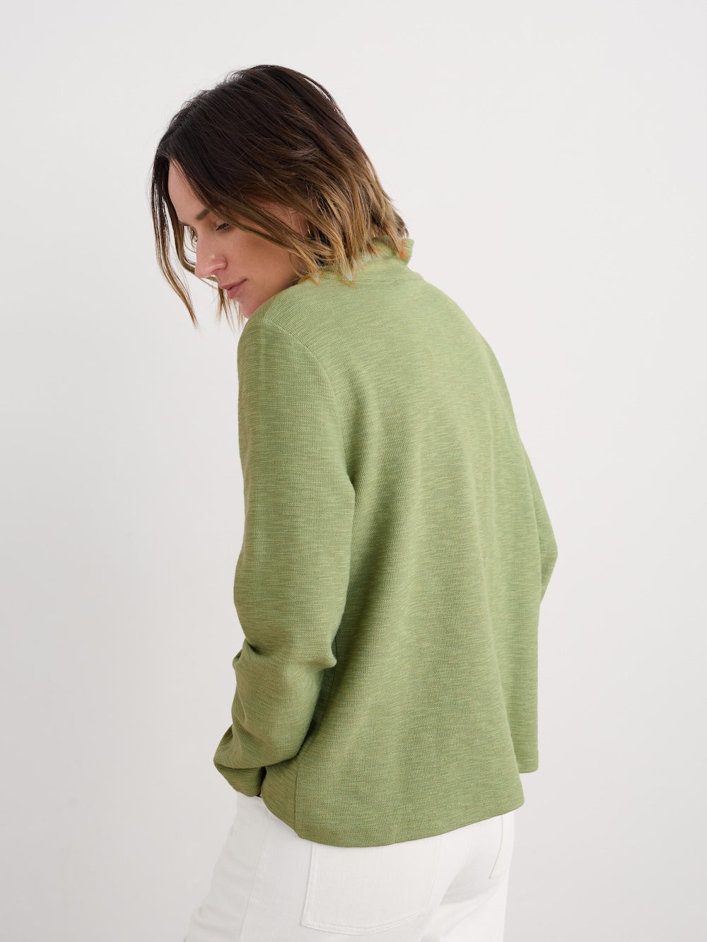 Woman wearing green long sleeve shirt